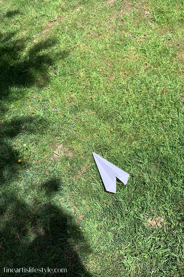 paper plane on grass photo